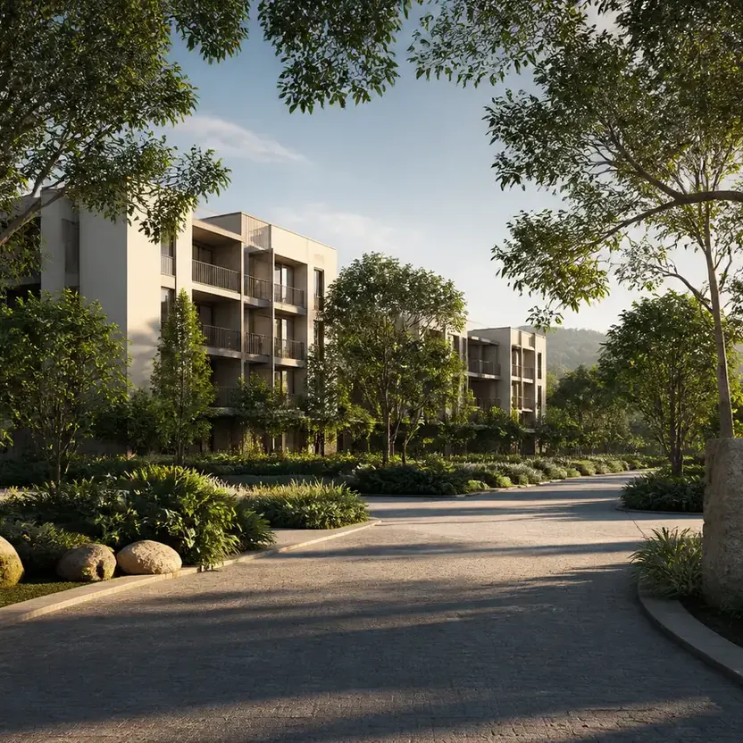 An arrival drive between low-rise blocks and mature trees